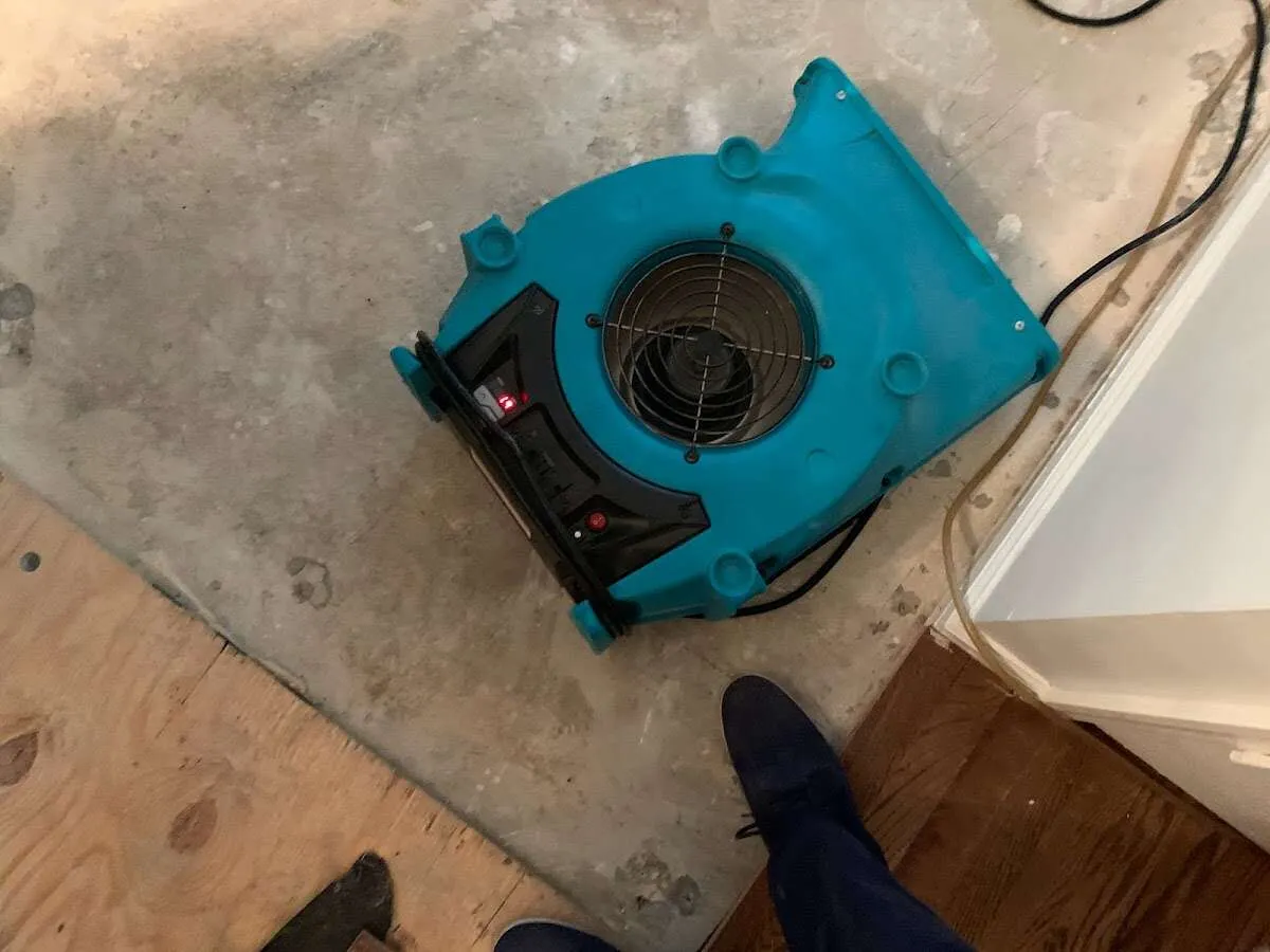 Air mover drying subfloor during Commercial Water Damage Restoration in Concord